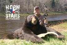Chris from Horn Stars Outdoors with 250 lb bear