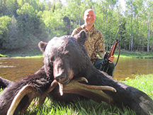 Sean is a happy hunter, bags black bear at taxis river outfitters